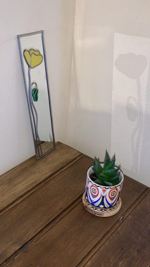 Mirror with yellow poppy.