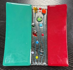 handmade fused glass plate, featuring a vibrant colour-blocked design
