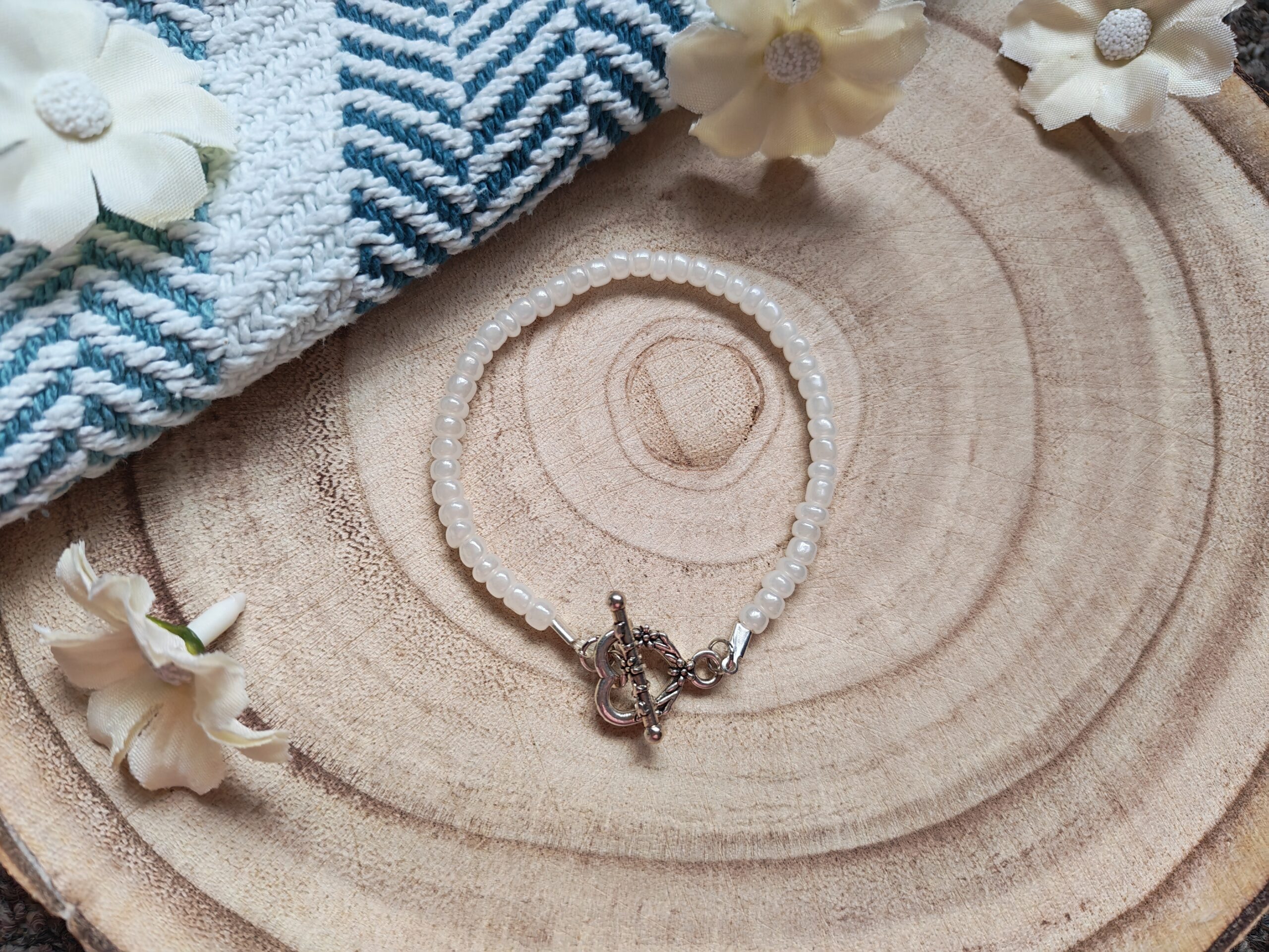 White beaded bracelet with heart t-bar
